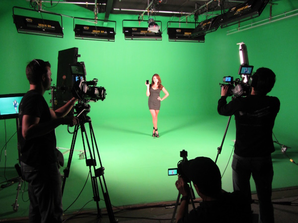 Videoing woman with green screen